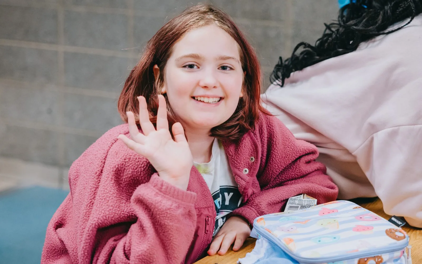 Greeley-girl in pink waving